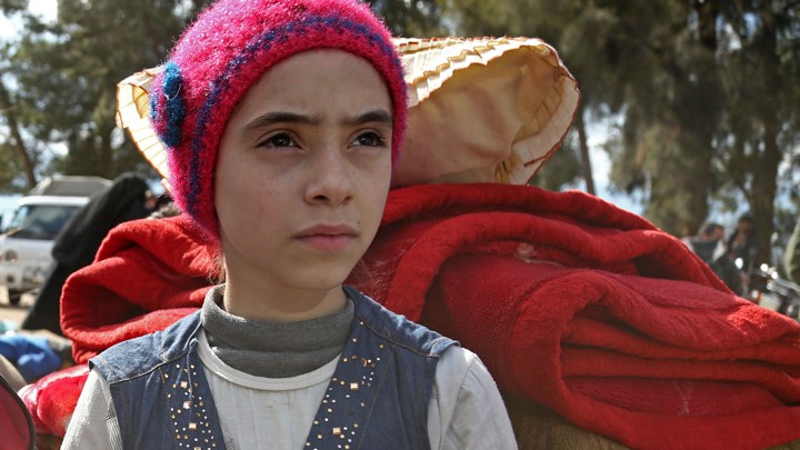 Syrian girl Noor, famous for broadcasting clips on social media about the regime-bombardments on the former rebel-held town of Jobar in Eastern Ghouta, arrives in Qalaat al-Madiq after being evacuated from Arbin on March 30, 2018.