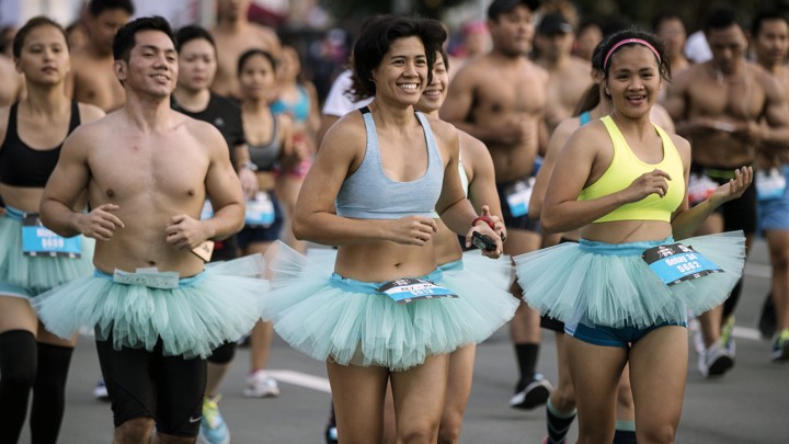 A group of runners wearing light-blue running tutus