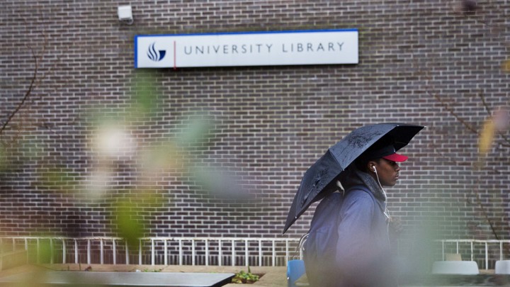 A student walks by the library at the Georgia State University campus in Atlanta.