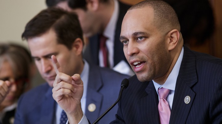 Representative Hakeem Jeffries of New York speaks into a microphone
