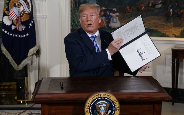 President Trump holding a signed memorandum