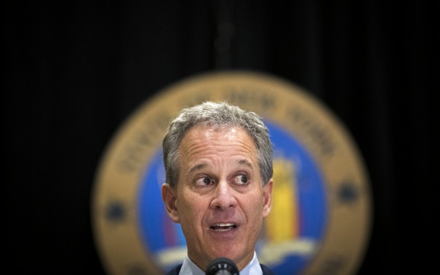 New York Attorney General Eric Schneiderman speaks at a microphone.