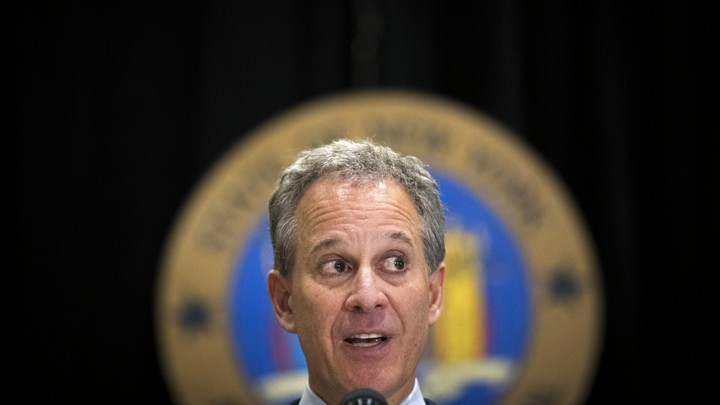 New York Attorney General Eric Schneiderman speaks at a microphone.