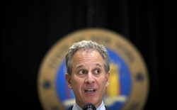 New York Attorney General Eric Schneiderman speaks at a microphone.