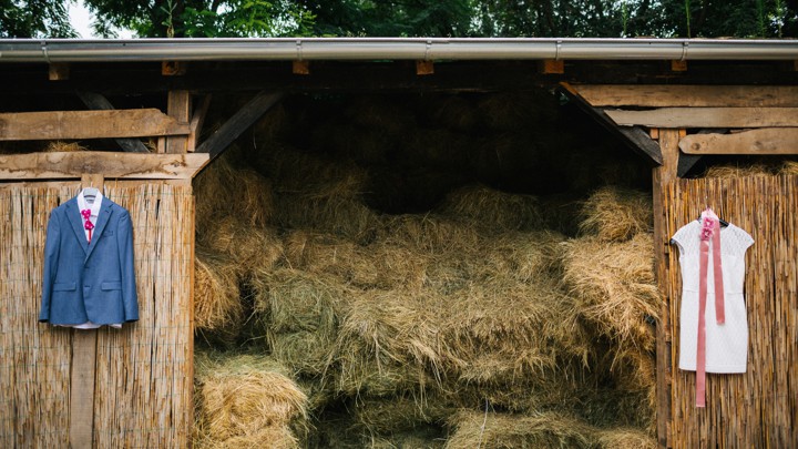 The Rise Of Barn Wedding Atlantic A Suit And Dress Hanging On Barn Wall Next To Hay Bales
