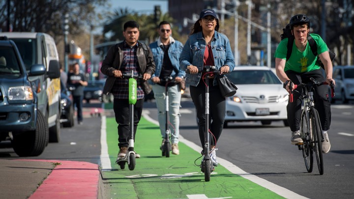 Should You Ride An Electric Scooter The Atlantic A Group Of People Rides Electric Scooters From Lime And Bird In Bike Lane While