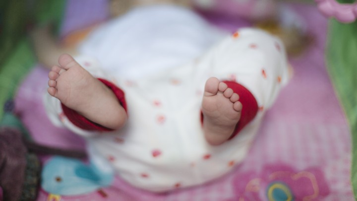 A baby lying on a blanket.