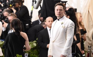 Elon Musk wearing a white suit