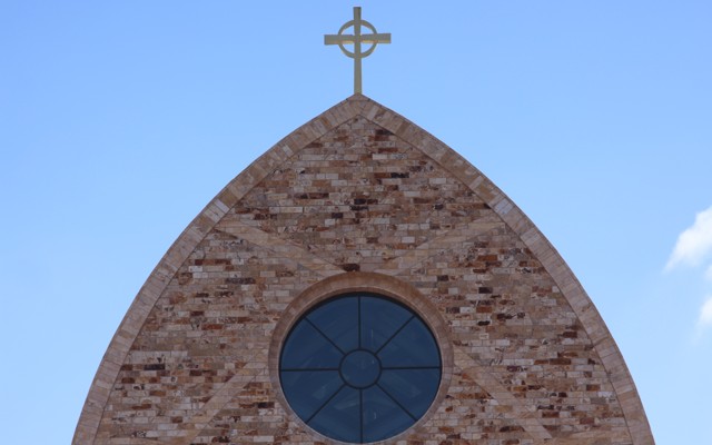 The cross atop Ave Maria Catholic Church, centrally located in Ave Maria, Florida, and across the street from Ave Maria University’s academic buildings