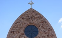The cross atop Ave Maria Catholic Church, centrally located in Ave Maria, Florida, and across the street from Ave Maria University’s academic buildings