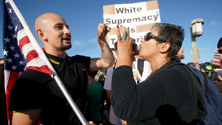 A protester and counter-protester face off at a Trump rally.