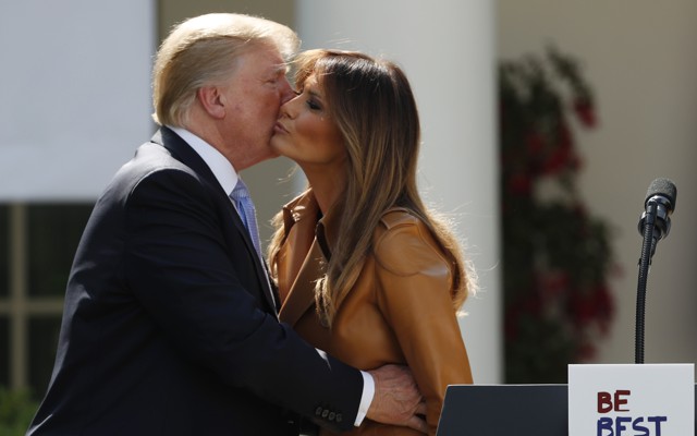 President Donald Trump and Melania Trump kissing on the cheek