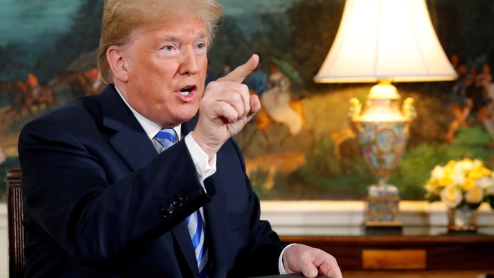 President Trump gestures after signing the memorandum