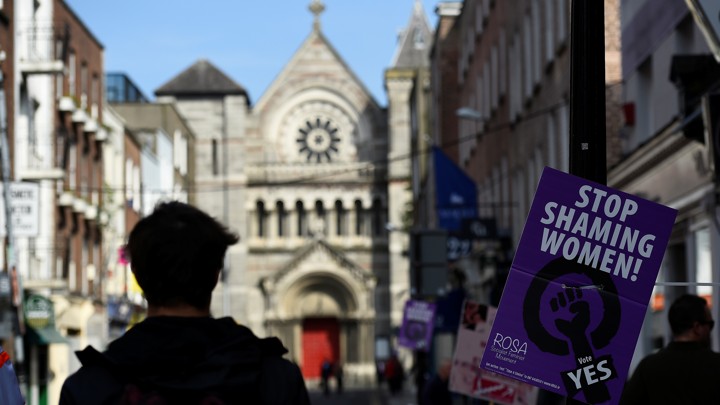 A man walks past a referendum poster