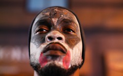 A black man with a painted face
