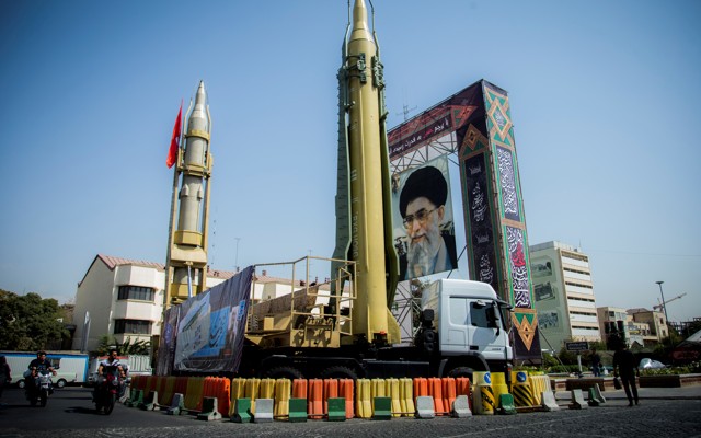 A display with missiles and a portrait of Ayatollah Ali Khamanei