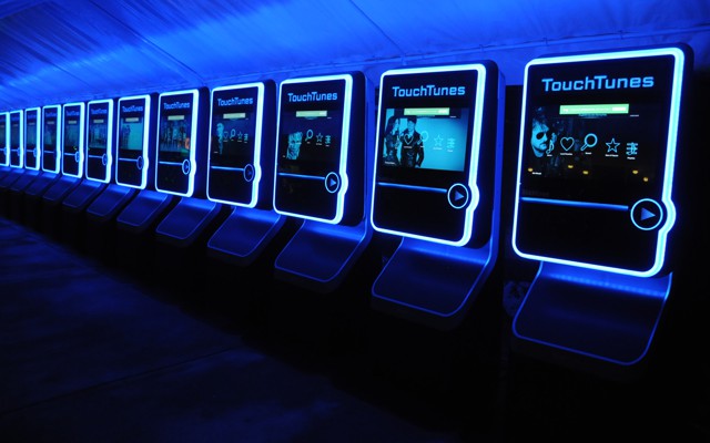 A row of TouchTunes digital jukeboxes