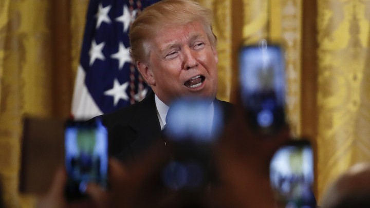 President Trump speaks in front of raised cell phones