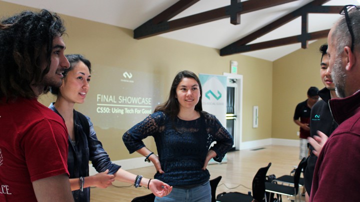 Students and faculty are pictured in conversation.