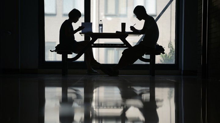 Students working in silhouette