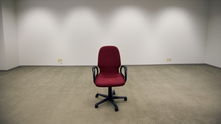 An office chair sitting in an empty room