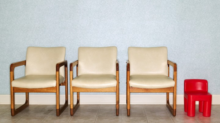 Adult chairs and a child's chair in a clinic waiting room