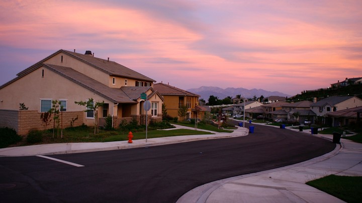 Sunset on a suburban residential block with mountains in the background
