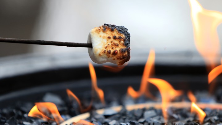 A marshmallow roasting over a fire