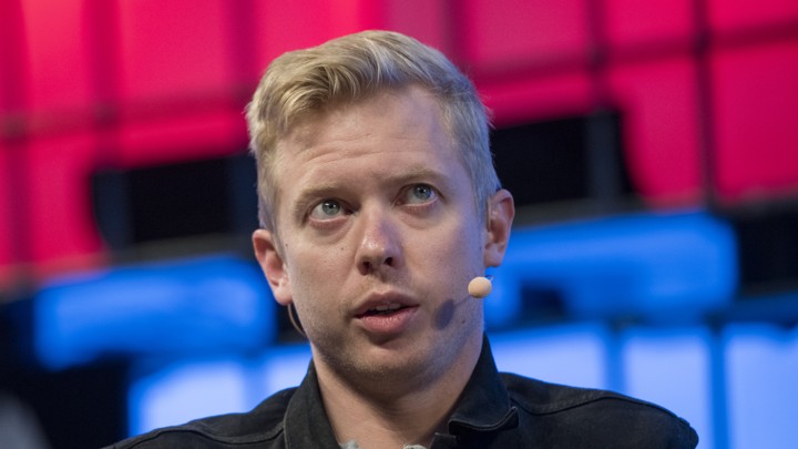 Steven Huffman speaks on stage at a conference.