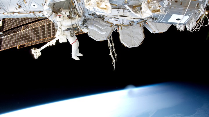An astronaut works on the outside of the International Space Station