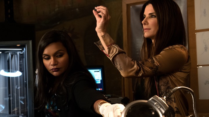 Amita (Mindy Kaling) and Debbie (Sandra Bullock) examine counterfeit jewels in 'Ocean's 8'