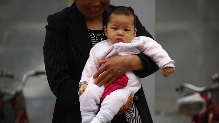 A woman holds a baby.