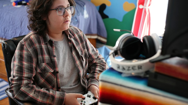 A boy holding a video-game controller