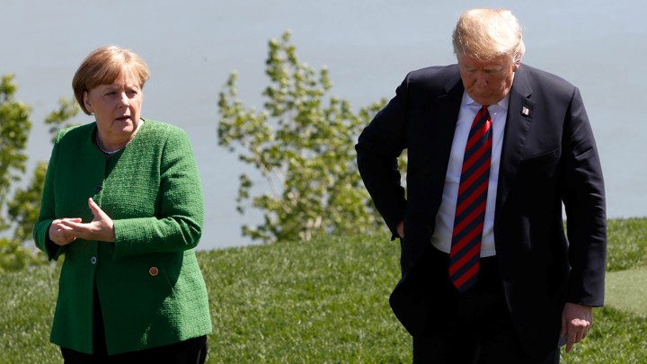 German Chancellor Angela Merkel talks with President Trump at the G-7 summit in Charlevoix, Quebec, Canada on June 8, 2018.