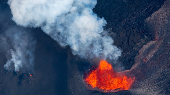 A volcano spewing red and orange lava