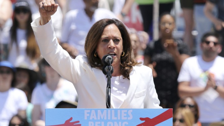 The California senator Kamala Harris raises her right fist at an immigration rally in Los Angeles