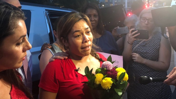 Woman surrounded by reporters
