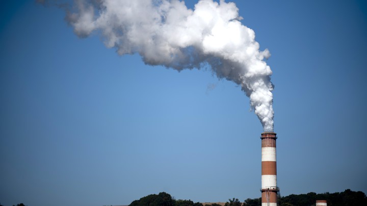 A plume of exhaust rises from a smokestack