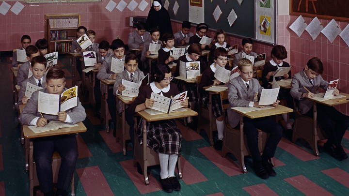 A group of students sits in a parochial-school classroom