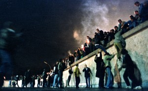 East German citizens climb over the Berlin Wall into West Berlin. 