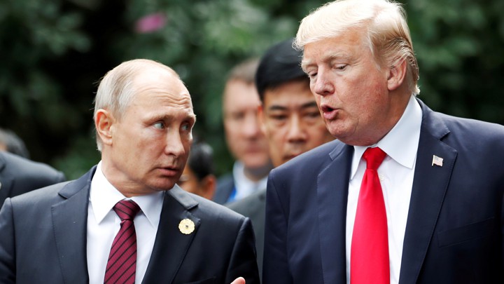 U.S. President Donald Trump and Russia's President Vladimir Putin talk during the family photo session at the APEC Summit in Danang, Vietnam November 11, 2017.