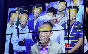 A screen shows the faces of several men as identified by Face++'s facial recognition software.