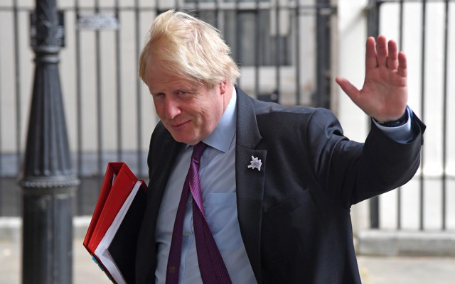 Now-former British Foreign Secretary Boris Johnson waves as he leaves Downing Street on June 28, 2018.