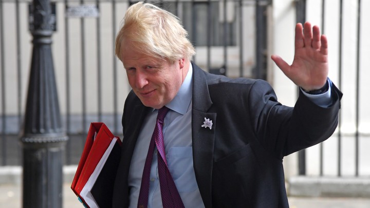 Now-former British Foreign Secretary Boris Johnson waves as he leaves Downing Street on June 28, 2018.