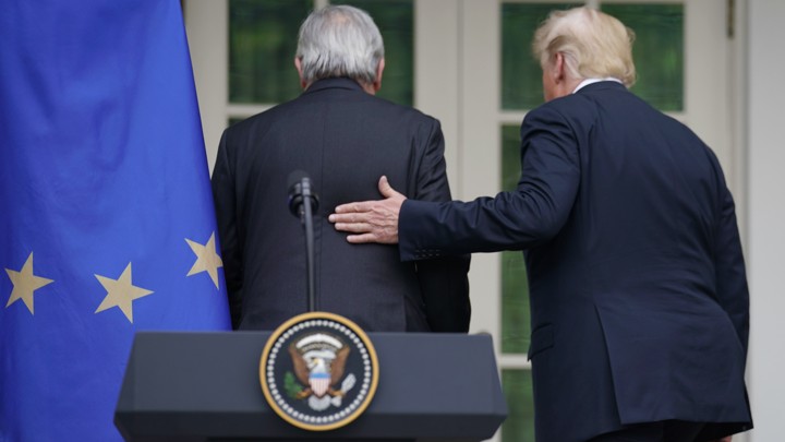 Trump places his hand on Juncker's back following a joint press conference at the White House Rose Garden.