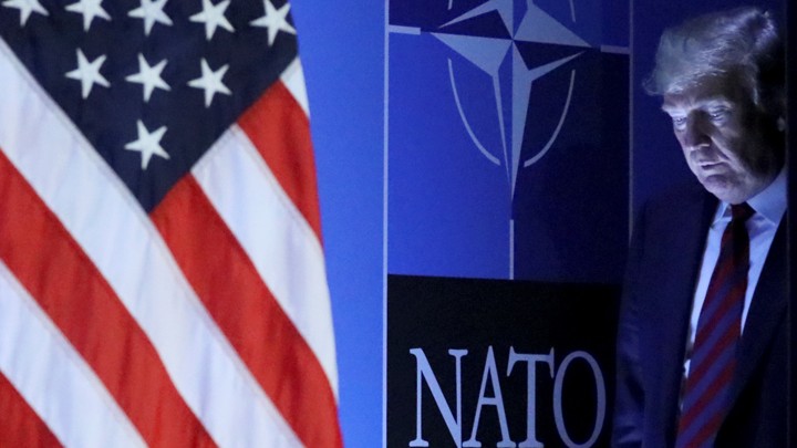Donald Trump arrives at a news conference after participating in the NATO summit