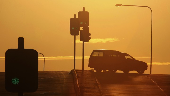 A car turns at a traffic light.