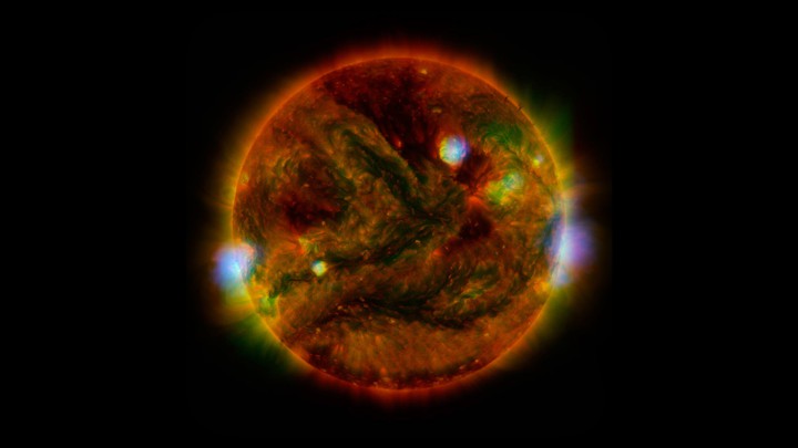 Regions of the sun highlighted in red, orange, green, blue, and other colors
