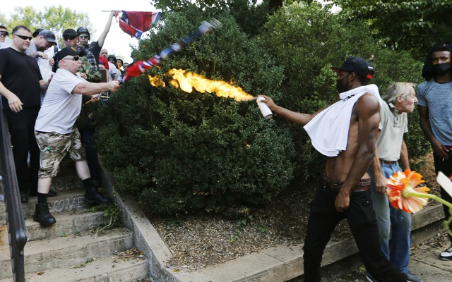 Corey Long sprays a makeshift flamethrower at white nationalist demonstrators