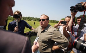Alex Jones surrounded by people holding cameras